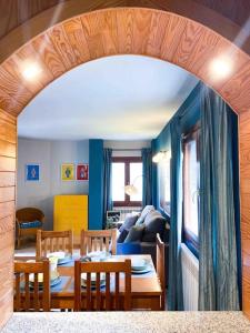 a room with a table and chairs and a living room at Único Piso Colorido y Divertido En Ransol - Increibles Vistas al Rio y Naturaleza - Ideal Familias in Andorra la Vella