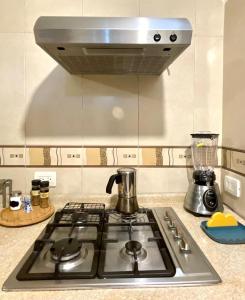 a stove top with a coffee pot on top of it at Hospédate en Paseo Santa Lucía - LOFT in Monterrey