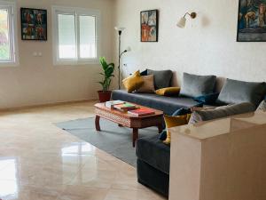 a living room with a blue couch and a table at Superb apartment in the heart of Tangier in Tangier