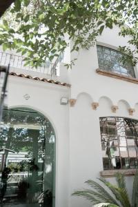 an entrance to a white building with a glass door at Casa Lomah WTC in Mexico City