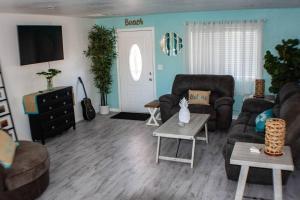 a living room with a couch and a table at Good vibes, amazing backyard, plenty of parking in Lake Havasu City