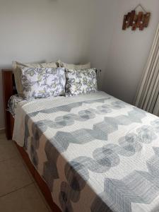 a bed with a blanket and pillows on it at flat serra negra - bezerros - PE flat 007 - 009 in Bezerros +26 photos