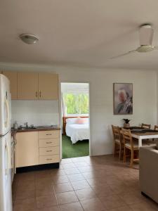 a kitchen and dining room with a table and a room at Coral Reef Resort in Cairns