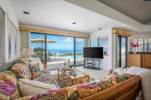 a living room with a couch and a view of the ocean at Oceanview Luxury Villa Pool & SPA in Kailua-Kona