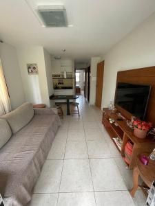 a living room with a couch and a flat screen tv at flat serra negra - bezerros - PE flat 007 - 009 in Bezerros