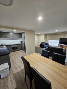 a conference room with a large wooden table and chairs at Top of the Town Motel & Apartments in Benalla