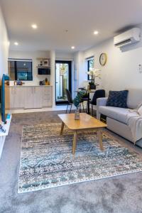 a living room with a couch and a table at Charming Downtown hideaway 1 bed 1 bath in Christchurch