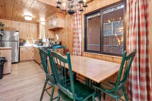 a kitchen with a wooden table and chairs at The Sugar Loft - Cozy cabin located in one of the quietest neighborhoods! Relax and recharge! in Sugarloaf +9 photos