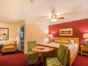 a hotel room with a bed and a table and chairs at The Inn on Pine in Calistoga