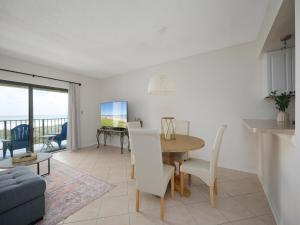 a dining room and living room with a table and chairs at Jacksonville Sea Spray 2B, 1 Bedroom, Beachfront, Sleeps 2 in Jacksonville Beach