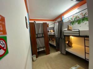 a small room with two bunk beds in it at Alex Hostel in Ha Long
