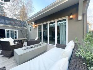 a patio with a couch and chairs and a fire pit at ~SJ Glass Sanctuary W/ Firepit/Cafe/Office/BBQ~ in San Jose