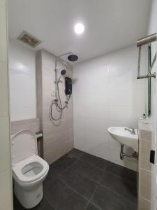 a bathroom with a toilet and a sink at E Hotel in Kulim