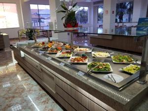 a buffet line with many plates of food on it at Lacqua di Roma I in Caldas Novas