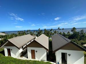 a row of houses with the ocean in the background at The Crow's Nest Resort Fiji in Korotogo
