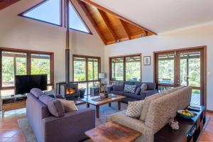 a living room filled with furniture and a fireplace at Tintagel Estate I Private Properties in Forest Grove