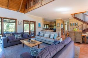 a living room with couches and a table at Tintagel Estate I Private Properties in Forest Grove