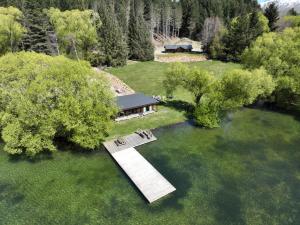 an overhead view of a house in a field with trees at Blue Mountain Lake Lodge in Fairlie