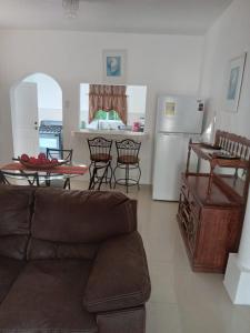 a living room with a couch and a table at Comfy Guest Rooms in Port Antonio