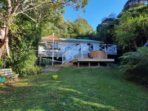 a house in the middle of a yard at Mahakipawa Waterfront Hideaway - Belvue Bay Home in Linkwater