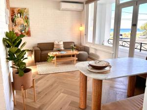 uma sala de estar com uma mesa e um sofá em Houston Beachfront Apartments em Gold Coast