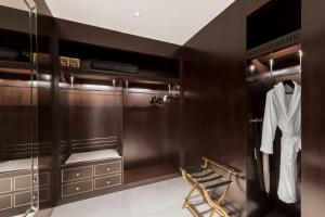 a walk in closet with a robe and a chair at The St. Regis Chengdu in Chengdu
