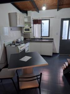a kitchen with a table and a stove top oven at Espacio km3 in Comodoro Rivadavia