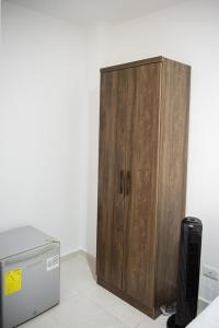 a wooden cabinet sitting next to a refrigerator at Alojamiento Acogedor con excelente ubicacion D in Medellín