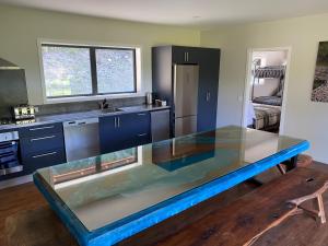 a kitchen with a large aquarium in the middle of it at Blue Mountain Lake Lodge in Fairlie