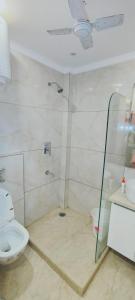 ein Bad mit einer Dusche und einem WC in der Unterkunft Vinanda Home Stay in Neu-Delhi