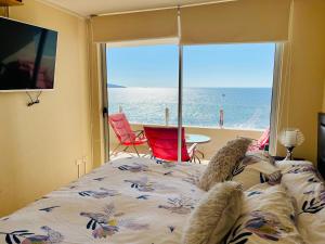 a bedroom with a bed with a view of the ocean at Vacations in La Serena in La Serena