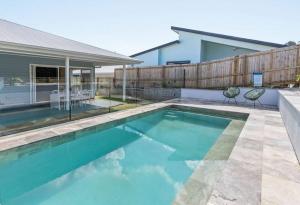 a swimming pool in the backyard of a house at Blue Tide in Lennox Head