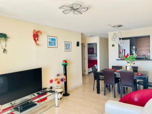 a living room with a couch and a table with chairs at Vacations in La Serena in La Serena