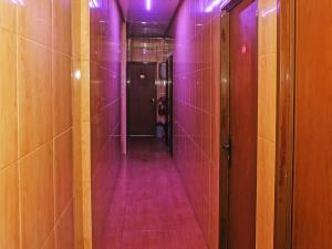 an empty corridor with purple lights in a bathroom at OYO 92674 Hotel Ciputat in South Tangerang