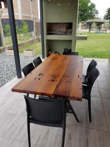 una mesa de madera con 4 sillas alrededor en Residencial Las Lechuzas en 