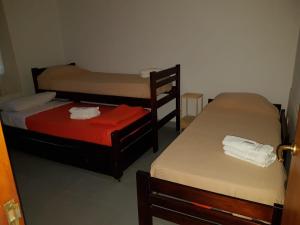 a room with three bunk beds in it at Residencial Las Lechuzas in Villa Anizacate