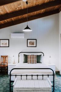 a bedroom with a bed and a wooden ceiling at Ilkley House - A Refreshing Family Rural Getaway in Eurunderee