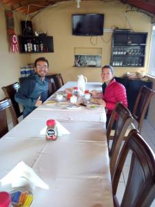 two men sitting at a table in a restaurant at La Posada del Conde Lodge in Cabanaconde