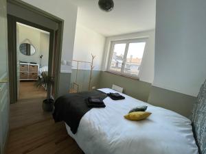 a bedroom with a large bed with two pillows on it at TheLighthouse Logement cozy idéalement situé in Calais