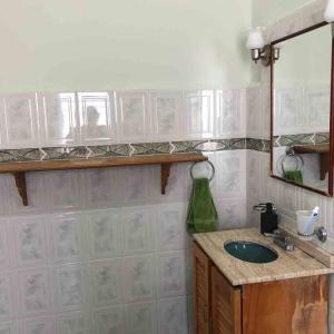 a bathroom with a sink and a mirror at Habitación con terraza privada in Mexico City