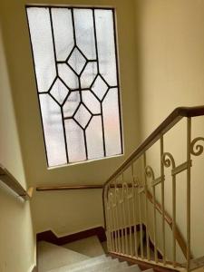 a staircase with a large window in a house at Habitación con terraza privada in Mexico City