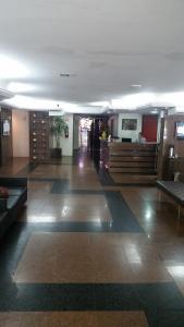a lobby of a building with a room with tables and a unintention at AP 219 Victory Flat em Tambaú in João Pessoa +81 photos