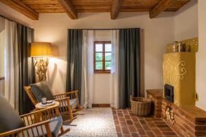 a living room with a couch and chairs and a window at steiRerBLiCke - Vinothek Petzles in Sankt Nikolai im Sausal