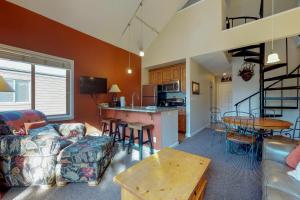 a living room with a couch a table and a kitchen at Year Round Getaway 301 in Breckenridge