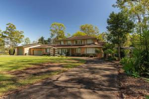 a large house with a driveway in front of it at Cundletown Cove in Cundletown