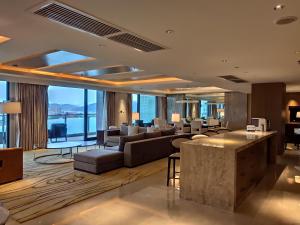 a living room with furniture and a large window at JW Marriott Hotel Sanya Dadonghai Bay in Sanya