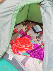 a green tent with a bed in it at Misty Mountains Holiday Homes in Vattavada