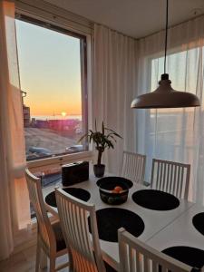 a dining room with a table and chairs and a window at Beach house in Kalajoki