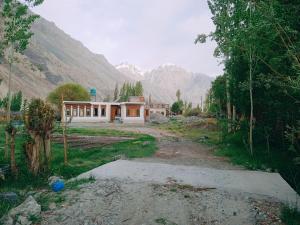 a house in the middle of a field with a mountain at Nubra Holiday in Deskit