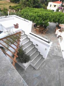 un conjunto de escaleras con plantas en un patio en Stellinas Pretty House, en Ándros